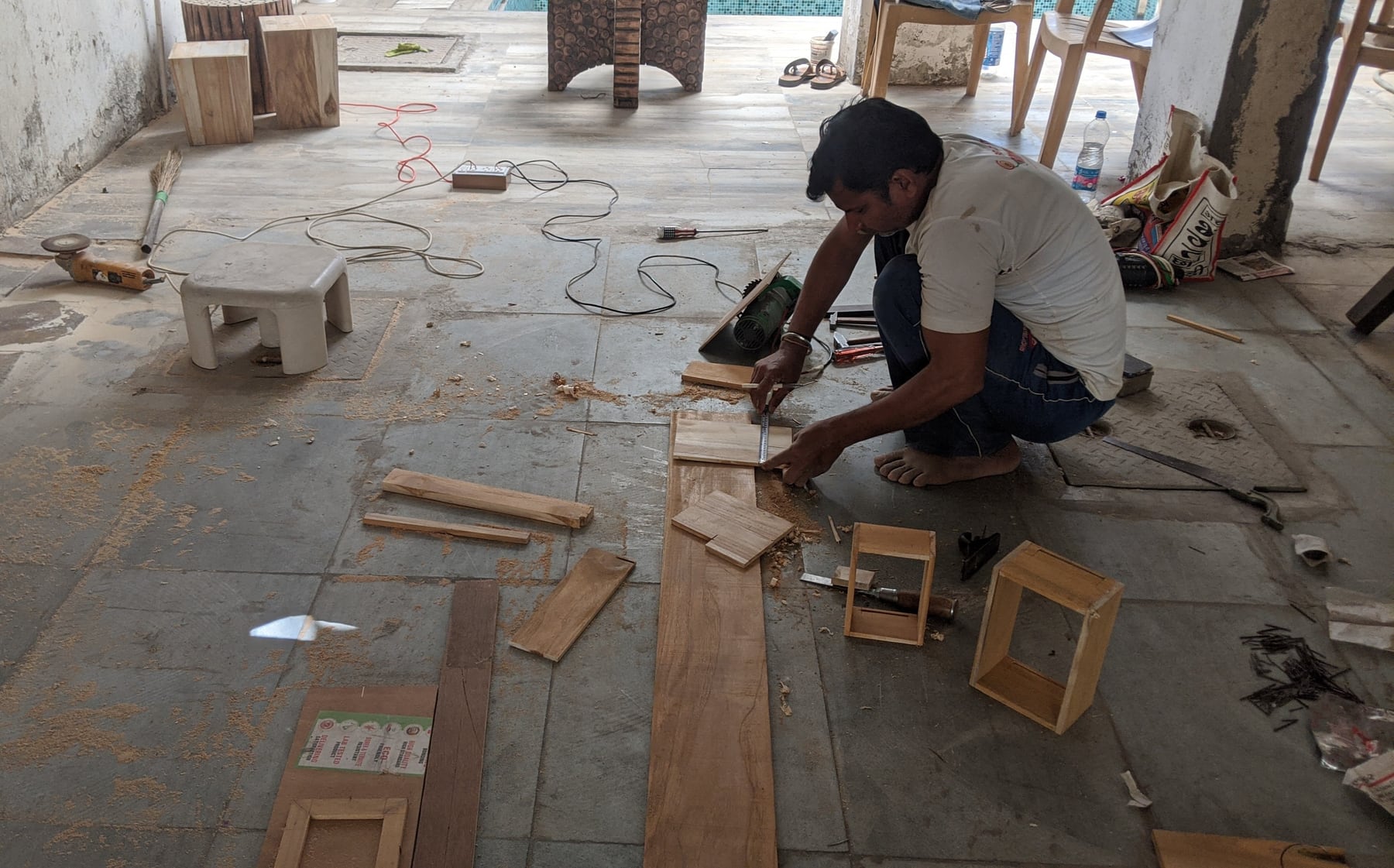 A Saag artisan measuring wood in the workshop