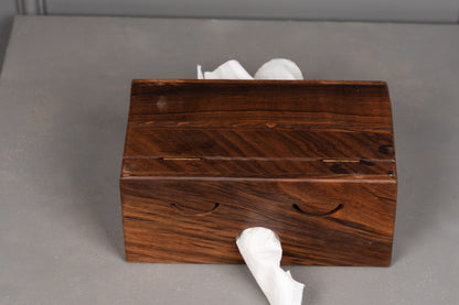 Wooden tissue box with tissues on a gray surface
