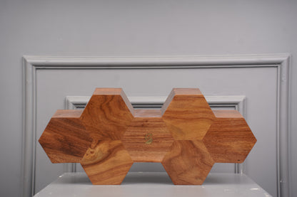 Wooden honeycomb block on a gray surface with a neutral background