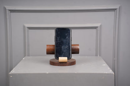 Smartphone on a wooden stand against a gray background